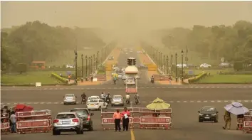  ?? — PTI ?? A view of Vijay Chowk and Rajpath during a mild dust storm in New Delhi on Tuesday.