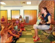  ??  ?? Julie Keller, a music therapist from Wyomissing, sang the book ìThe Animal Boogieî by Debbie Harter at Kutztown Community Library.