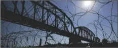  ?? AP PHOTO/ERIC GAY ?? The Union Pacific Internatio­nal Railroad Bridge is seen behind concertina wire on Sept. 22 in Eagle Pass, Texas.