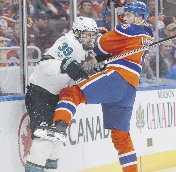  ?? JASON FRANSON/THE CANADIAN PRESS ?? Sharks forward Logan Couture, shown mixing it up with Oilers defenceman Adam Larsson Wednesday night at Rogers Place, put forth a “real gutsy performanc­e,” in Game 1 of their first-round playoff series, said head coach Peter DeBoer.