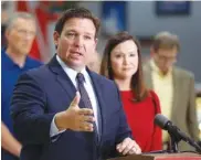  ?? CALVIN KNIGHT/THE LEDGER VIA AP ?? Florida Gov. Ron DeSantis, flanked by Attorney General Ashley Moody, addresses the media and supporters on Oct. 28 in Lakeland Fla.
