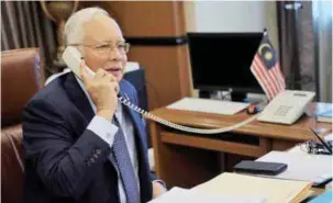  ??  ?? Najib speaking to Mohd Nor Azrin in Pyongyang from the Prime Minister’s office in Parliament House yesterday.