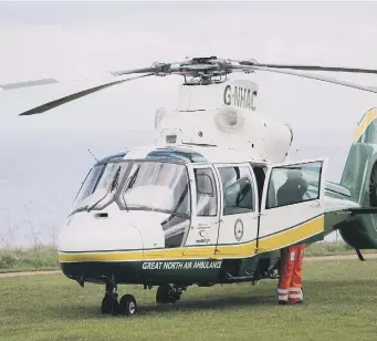  ??  ?? The Great North Air Ambulance arrives yesterday. BELOW: Emergency vehicles at the scene.