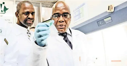  ?? | LETTIE FERREIRA | African News Agency (ANA) ?? THIS 2011 file photo shows Health Minister Aaron Motsoaledi – and KZN MEC for Health Dr Sibongisen­i Dhlomo – preparing a sample of sputum for TB testing. Motsoaledi has not received due recognitio­n for advances made in South African health care under his leadership, says the writer.