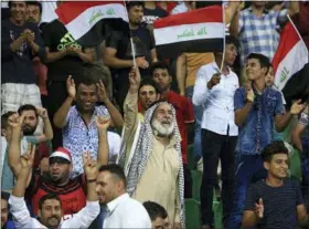  ?? THE ASSOCIATED PRESS ?? FILE - In this file photo, soccer fans wave national flags during a friendly match, in Basra, Iraq. An Iraq-Qatar match, part of a friendly soccer tournament this week with Syria and Qatar, is to start Wednesday in Basra. While friendly matches have...