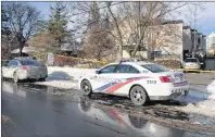  ?? CP PHOTO ?? Police cars are parked outside the home of billionair­e Barry Sherman on Saturday in Toronto. Apotex founder Sherman and his wife Honey were found dead in the north Toronto mansion on Friday. Police are awaiting the results of autopsies performed on the...