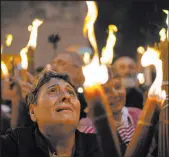  ?? Leo Correa
The Associated Press ?? A Christian Orthodox pilgrim holds a candle Saturday during the Holy Fire ceremony at the Church of the Holy Sepulchre in the Old City of Jerusalem.