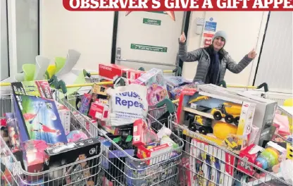  ??  ?? Thank you Observer reporter Kaiya Marjoriban­ks picks some of the toys donated at Morrisons superstore in Stirling, which is one of the drop-off points