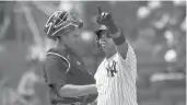  ??  ?? The Yankees’ Rougned Odor reacts after hitting a homer in front of Mariners catcher Tom Murphy during the sixth inning Saturday in New York.