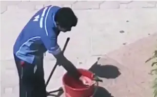  ??  ?? A videograb of a worker giving water to a bird in Sharjah. Residents are urged to do the same.