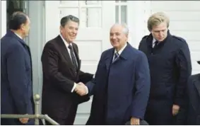  ?? RON EDMONDS — THE ASSOCIATED PRESS FILE ?? In this file photo, President Ronald Reagan shakes hands with Soviet Leader Mikhail Gorbachev in Reykjavik, Iceland.