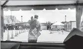  ?? BRITTAINY NEWMAN/THE NEW YORK TIMES ?? A National Guard member directs traffic Wednesday at a drive-thru coronaviru­s test facility in the Bronx, New York.