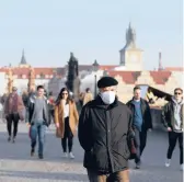  ?? PETR DAVID JOSEK/AP ?? The Czech Republic last week had a record 8,500 people hospitaliz­ed with COVID-19. Above, a man walks across the Charles Bridge on Feb. 25 in Prague.