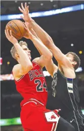  ?? JONATHAN DANIEL/GETTY IMAGES ?? The Bulls’ Lauri Markkanen takes the ball to the basket against the Bucks’ Brook Lopez on Monday at the United Center.