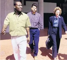  ?? TRIBUNE NEWSPAPERS/FILE ?? At left, a 1999 photo shows former SabreTech maintenanc­e workers Eugene Florence, left, and Mauro Ociel Valenzuela-Reyes leaving court with their lawyer Jane Moscowitz. Above, a 1996 photo shows people aboard airboats searching the Everglades for...