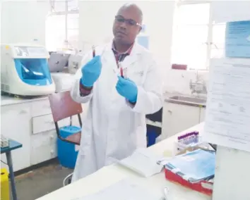  ??  ?? Hauna district hospital medical laboratory scientist Mr Patrick Simbi analysing samples for viral load testing