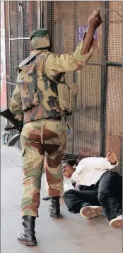  ?? PICTURE: MIKE HUTCHINGS/REUTERS ?? SHOW OF FORCE: A soldier beats an opposition party supporter outside the MDC headquarte­rs.