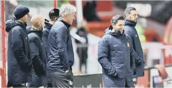  ??  ?? Sunderland manager Lee Johnson with his staff at Lincoln City’s LNER Stadium in December.