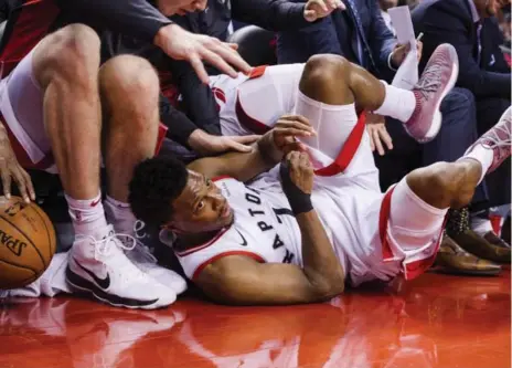  ?? CHRISTOPHE­R KATSAROV/THE CANADIAN PRESS ?? Raptors guard Kyle Lowry falls to the floor during the first half against the Charlotte Hornets at the Air Canada Centre on Wednesday.