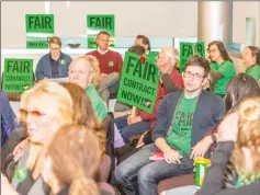  ?? Cory Rubin/The Signal ?? Faculty members crowd the College of the Canyons board room prior to Wednesday’s board of trustees meeting wearing shirts and carrying signs demanding a “fair contract now.”