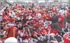 ?? John McCreary / For Hearst Connecticu­t Media ?? Greenwich players pile up for a team photo with their Class LL plaque after winning the state championsh­ip on Saturday.