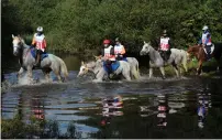  ?? Supplied photo ?? The participan­ts cross a stream during the race. —