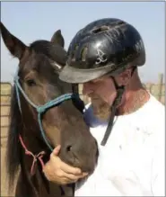  ?? PHOTOS BY RICH PEDRONCELL­I — THE ASSOCIATED PRESS ?? Inmate Chris Culcasi spends a few moments with Zephyr, at the end of a training day at Wild Horse Program run at the Sacramento County Sheriff’s Department’s Rio Cosumnes Correction­al Center in Elk Grove on Sept. 9. Inmates spend 40 hours a week...