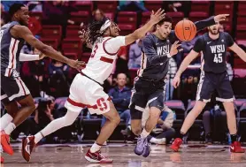  ?? Scott Strazzante/The Chronicle ?? Washington State’s Myles Rice grabs a loose ball from Stanford’s Kanaan Carlyle on Thursday. Rice scored a WSU freshman-record of 35 points in the Cougars’ win.