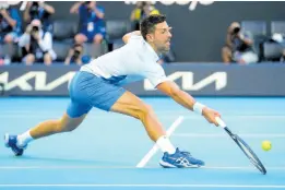  ?? AP ?? Serbia’s Novak Djokovic plays a forehand return to the United States’ Taylor Fritz during their quarterfin­al match at the Australian Open tennis championsh­ips at Melbourne Park, Melbourne, Australia yesterday.