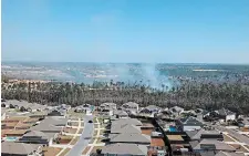  ?? FLORIDA FOREST SERVICE ?? Smoke rises from a wildfire in Bay County, Fla., on Saturday. More than 1,100 homes have been evacuated due to fires in the region.