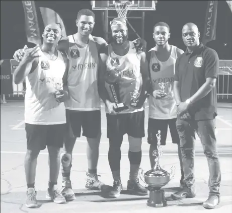  ??  ?? Members of the victorious Pit-bulls 3.0 side posing with their spoils alongside tournament coordinato­r Rawle Toney (right) after clinching the inaugural Rawle Toney/Mackeson 3x3 Basketball Champion ship. From left to right are Ryan Stephney, Jermin Slater, Ryan Gullen and Travis Belgrave
