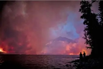  ?? NATIONAL PARK SERVICE VIA AP ?? The Howe Ridge Fire is seen Sunday from across Lake McDonald in Glacier National Park, Mont.