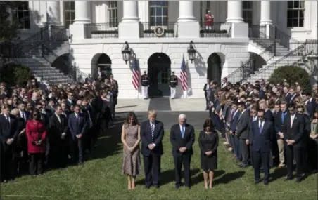  ?? CAROLYN KASTER — THE ASSOCIATED PRESS ?? President Donald Trump and first lady Melania Trump stand with Vice President Mike Pence, his wife Karen, and members of the White House staff during a moment of silence to remember the victims of the mass shooting in Las Vegas, on the South Lawn of...