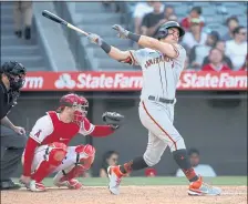  ?? KATELYN MULCAHY — GETTY IMAGES ?? Mike Tauchman hits a three-run home run during the Giants’ seven-run 13th inning against the Angels on Wednesday afternoon at Anaheim.