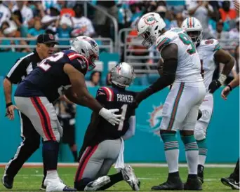  ?? BARRY CHIN/GLOBE STAFF ?? Patriots receiver DeVante Parker was slow to get up after taking a big hit in the third quarter. He was ruled out with a head injury.