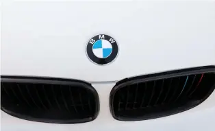  ??  ?? A BMW logo is seen on a car at the Internatio­nal Auto Show in Mexico City last week. The automaker is seeking partners to develop small electric cars. (Reuters)