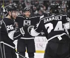  ?? Associated Press ?? Kings defenseman Sean Walker (left) celebrates scoring a goal with center Phillip Danault during the second period against the Buffalo Sabres, Monday, in Los Angeles. The Kings won 5-2.