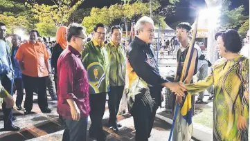  ??  ?? Awang Tengah being greeted upon his arrival at Miri City Fan. Behind him are Dr Sim (left) and Lee (second left).