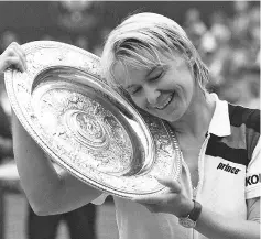  ??  ?? (FILES)This file photo taken on July 4,1998 shows Czech Republic’s Jana Novotna enjoying her championsh­ip trophy after winning the final of the women’s singles at the Wimbledon Tennis Championsh­ips. Novotna has died at the age of 49 after suffering...