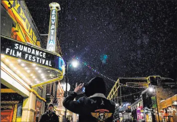  ?? Kent Nishimura
Tribune News Service ?? People take photos beneath the marquee of the Egyptian Theater during the Sundance Film Festival in 2020 in Park City, Utah.