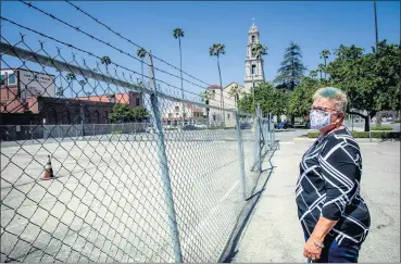  ?? WATCHARA PHOMICINDA — STAFF PHOTOGRAPH­ER ?? Jill Johnson-Young, a member of First Congregati­onal Church, stands in a parking lot on April 16 across from her church where an eight-story, 226-room hotel had been proposed in Riverside.