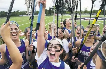  ?? Steph Chambers/Post-Gazette ?? Hampton's Rachel Hirst, with ink on her arm reading “No Regrets,” brings her team together after beating Oakland Catholic in the WPIAL Class 2A girls lacrosse championsh­ip Thursday.