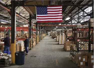  ?? (Bloomberg WPNS) ?? A U.S. flag adorns a warehouse at the Fiesta Tableware Co. factory in Newell, W.Va., in this file photo.