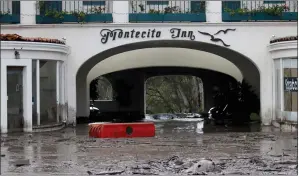  ?? AP PHOTO/DANIEL DREIFUSS, FILE ?? In this Tuesday photo, debris and mud cover the entrance of the Montecito Inn after heavy rain brought flash flooding and mudslides to the area in Montecito, Calif. At the height of his fame in 1928 Charlie Chaplin led a small group of investors who...