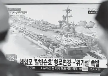  ?? Ahn Young-joon Associated Press ?? PEOPLE at a Seoul rail station watch a TV news program showing a file image of the Carl Vinson aircraft carrier. The U.S. ship is heading toward the region and is being joined by Japanese warships.