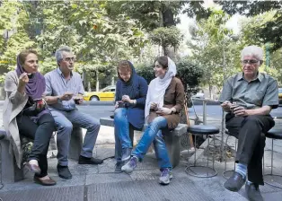  ?? Photo / AP ?? Iranians enjoy ice cream in northern Tehran. The price of milk has doubled in the space of a week.