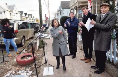  ?? Arnold Gold / Hearst Connecticu­t Media ?? New Haven Health Director Maritza Bond, center, speaks about the HUD funding for the city’s Healthy Homes Program at a press conference on Grafton Street in New Haven on Monday. Below, New Haven Mayor Justin Elicker, center, speaks about the HUD funding at the event Monday.