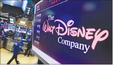  ?? AP PHOTO ?? The Walt Disney Co. logo appears on a screen above the floor of the New York Stock Exchange. Disney is buying a large part of the Murdoch family’s 21st Century Fox in a US$52.4-billion deal announced Thursday.