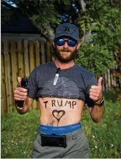  ?? CALLA KESSLER / PALM BEACH POST ?? Travis Bearman, of Orlando, awaits Trump’s motorcade Sunday on Southern Boulevard: “I’m just here to give him a thumbs up as he goes by.”