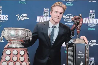  ?? JOHN LOCHER
THE ASSOCIATED PRESS ?? Connor McDavid poses with the Art Ross Trophy and Ted Lindsay Award at the NHL awards night Wednesday. The league made a point of noting the tragedies that impacted the hockey world and continent this season